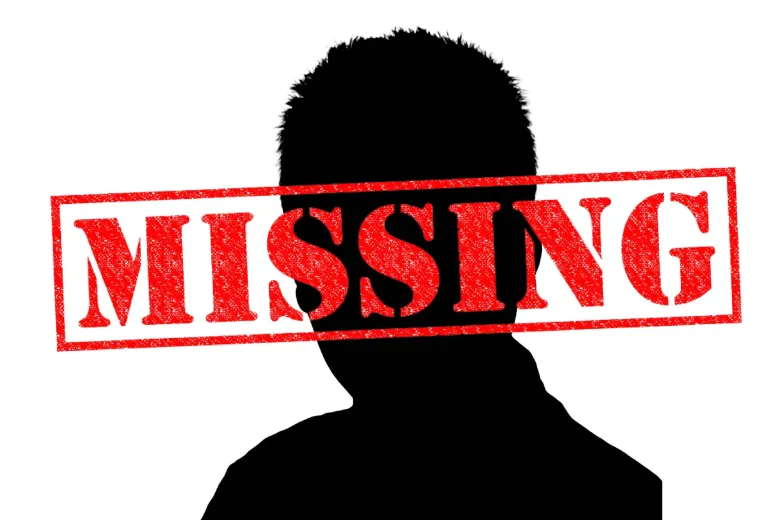 Silhouette of a head and shoulders with a red "missing" stamp